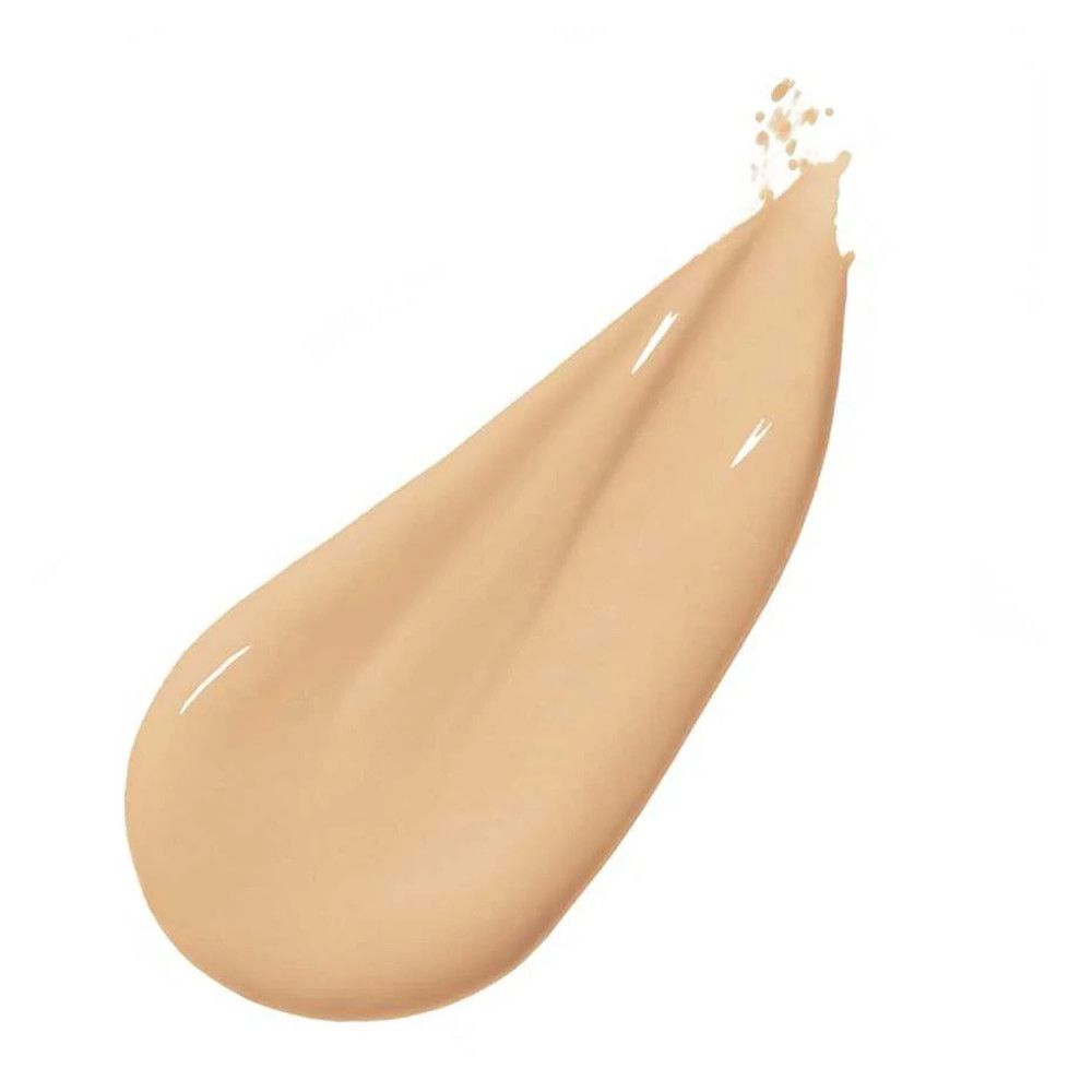 Beige Flüssigkeitstropfen. Glänzende Textur. Auf weißem Hintergrund.