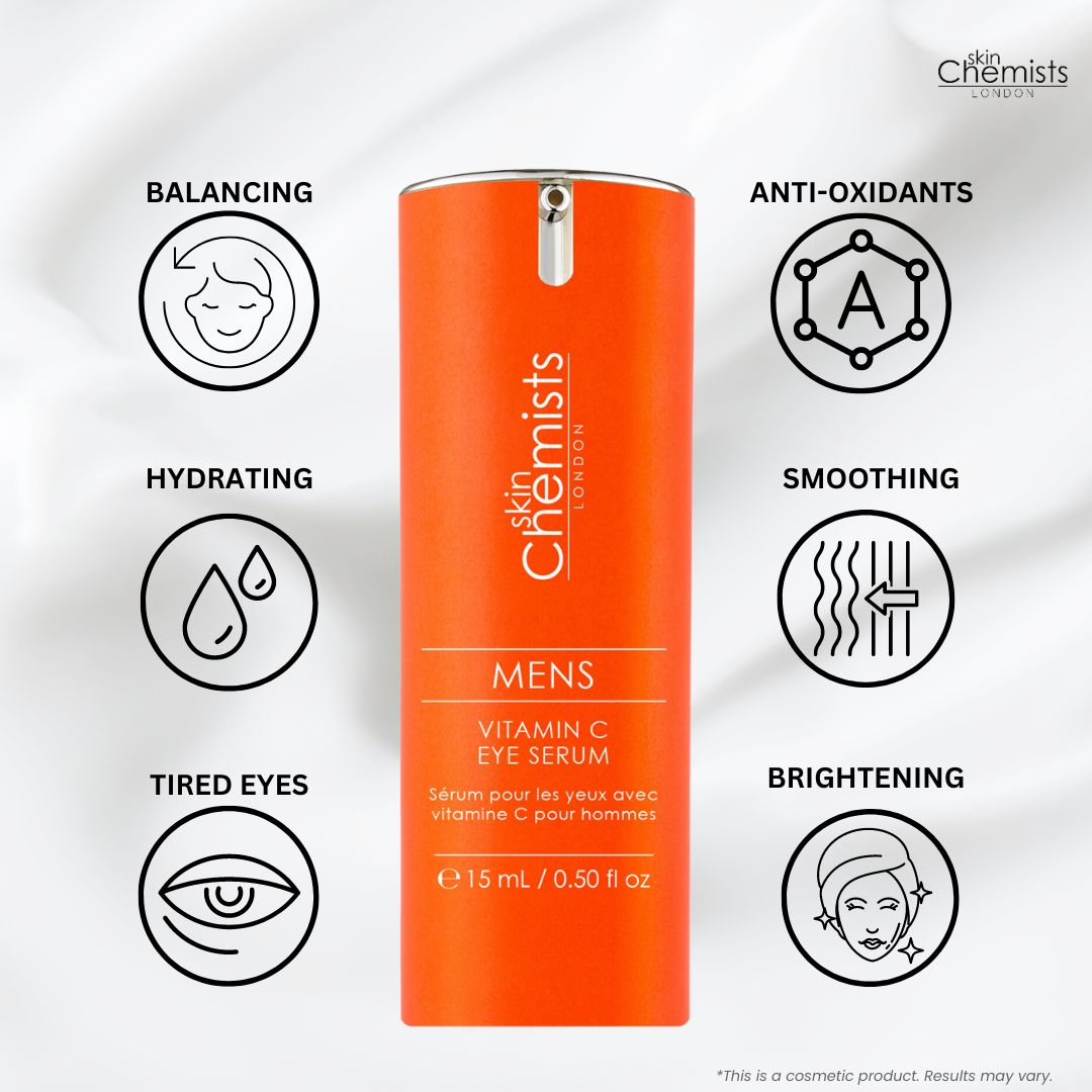 Orangefarbenes Serumfläschchen mit silberner Pumpe. Aufschrift: skinChemists LONDON, MENS Vitamin C EYE SERUM, 15 ml / 0.50 fl oz. Grafiken.