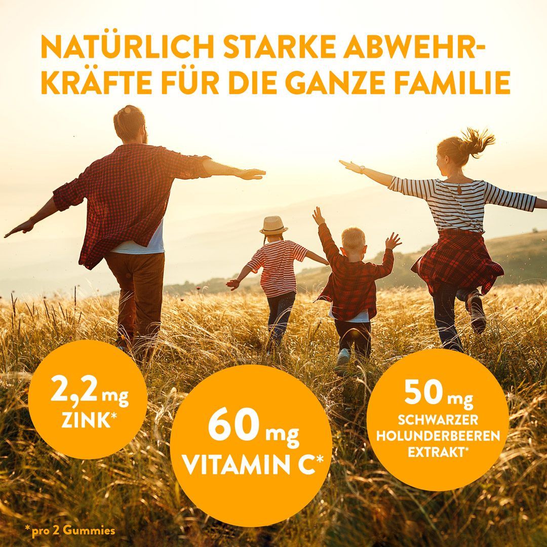Familie rennt im Sonnenuntergang. Kreise mit Text: 2,2 mg Zink, 60 mg Vitamin C, 50 mg Holunderbeerenextrakt. Text: 'Für die ganze Familie'.