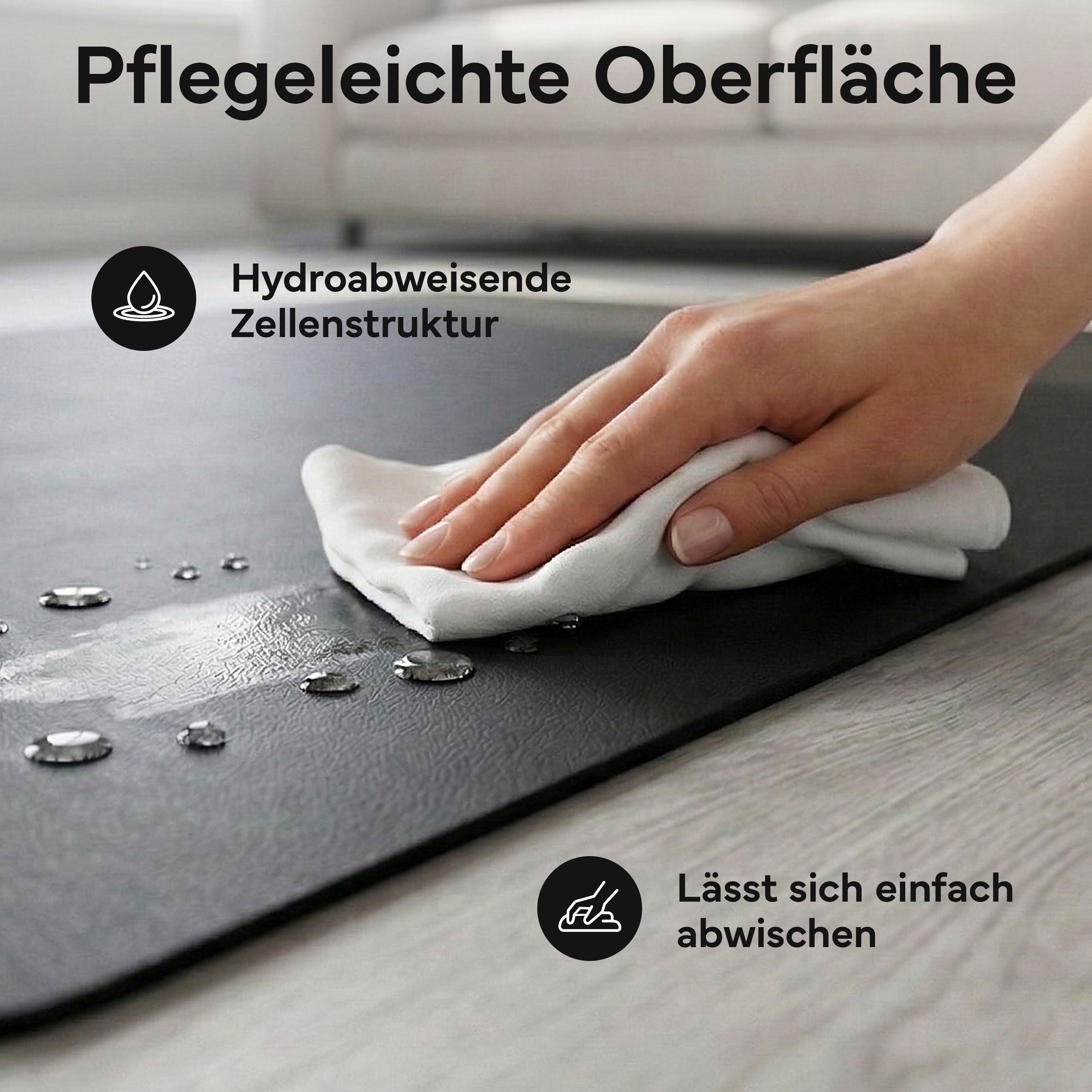 Hand wischt über schwarze Fitnessmatte. Text: Pflegeleichte Oberfläche. Hydroabweisende Zellenstruktur. Lässt sich einfach abwischen.