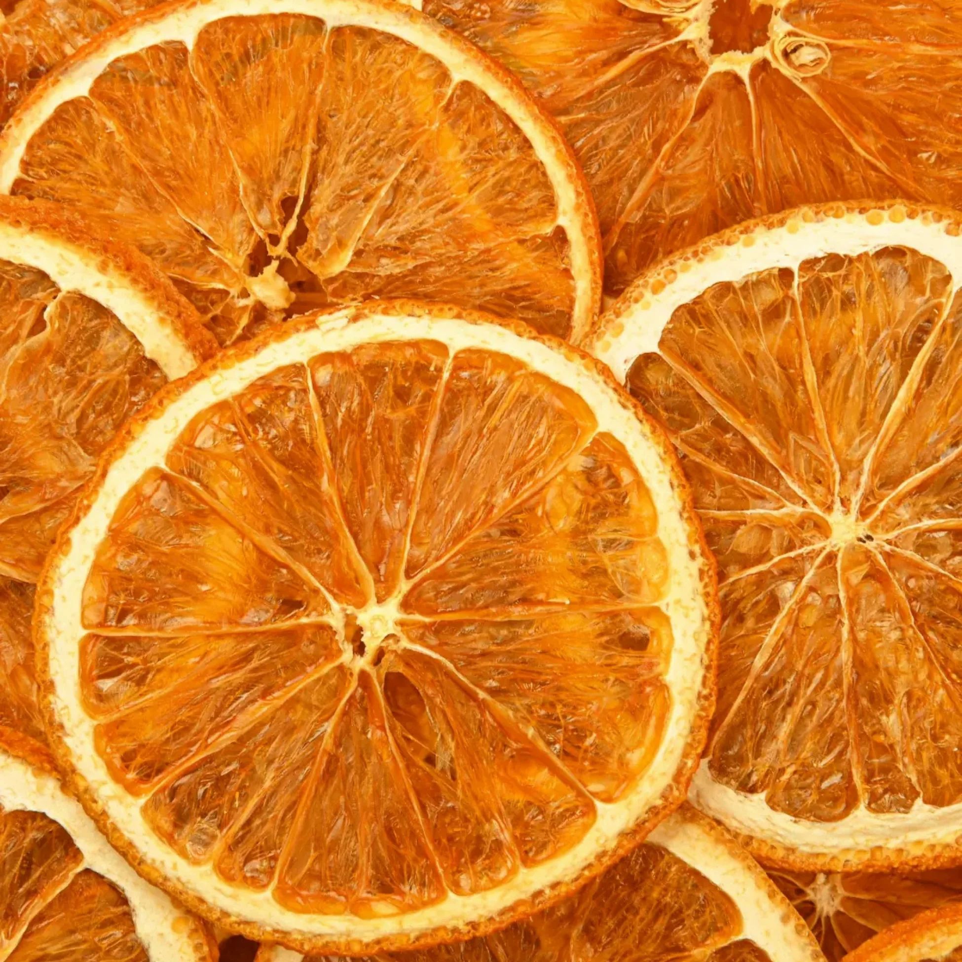 Nahaufnahme getrockneter Orangenscheiben. Runde, orangefarbene Scheiben mit sichtbarer Textur und Kern.