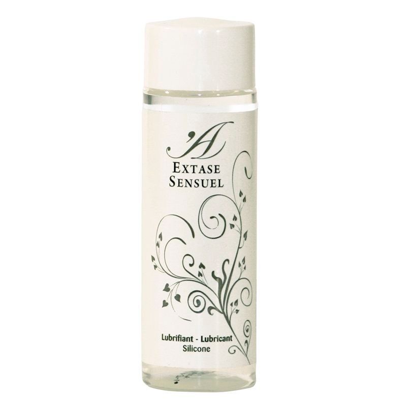Transparente Flasche mit weißem Deckel. Aufschrift: Extase Sensuel. Florales Muster. Aufschrift: Lubrifiant - Lubricant - Silicone.