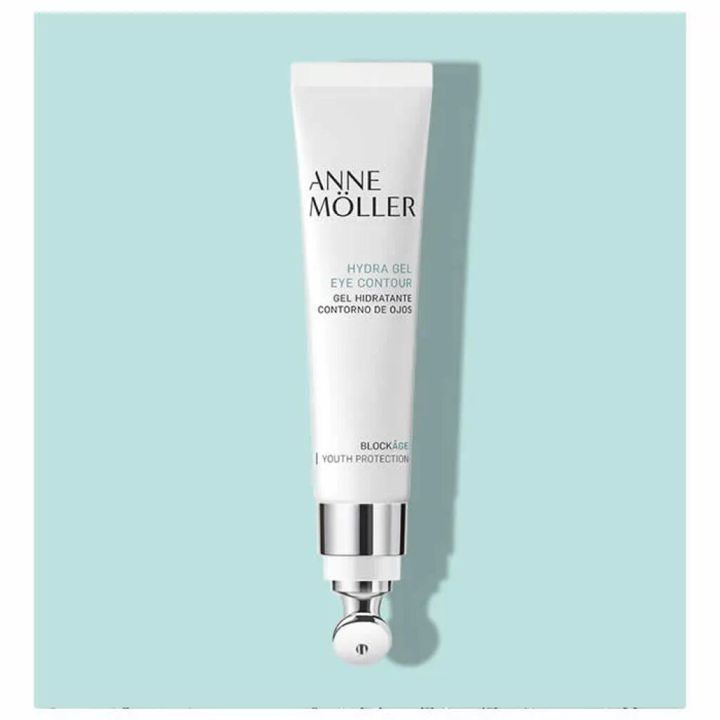 Weiße Tube mit silbernem Applikator. Aufschrift: Anne Möller, Hydra Gel Eye Contour. Mit Roll-on-Kopf. Auf blauem Hintergrund.