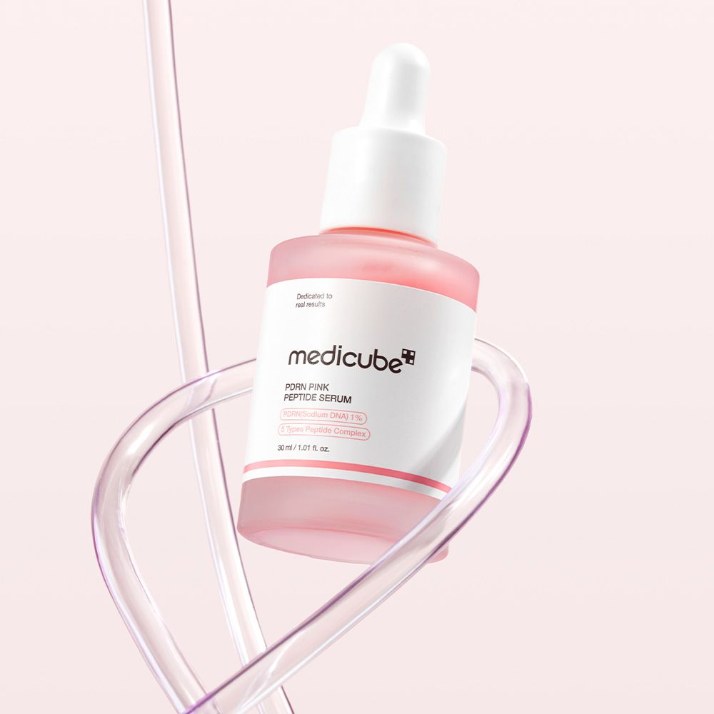 Medicube PDRN Pink Peptide Serum Flasche mit Pipette, umgeben von klaren Röhren.