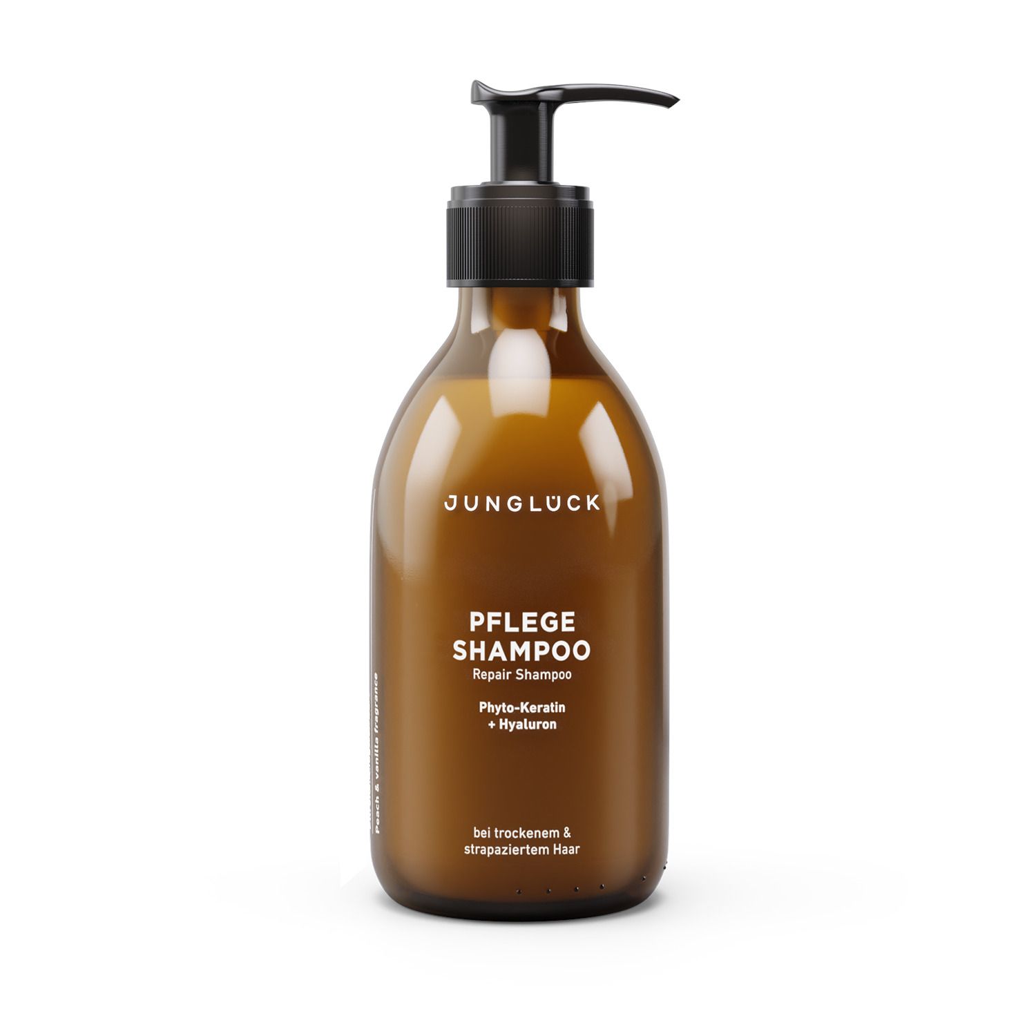 Braune Flasche mit schwarzem Pumpkopf. Aufschrift: JUNGLÜCK, PFLEGE SHAMPOO, Repair Shampoo. Für trockenes & strapaziertes Haar.