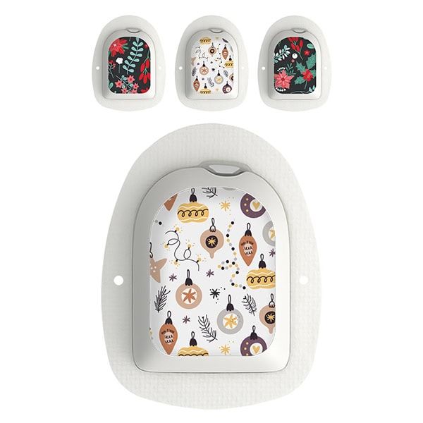 Mehrere Omnipod-Applikatoren mit weihnachtlichen Designs. Gezeigt sind verschiedene Muster mit floralen und Ornament-Motiven.