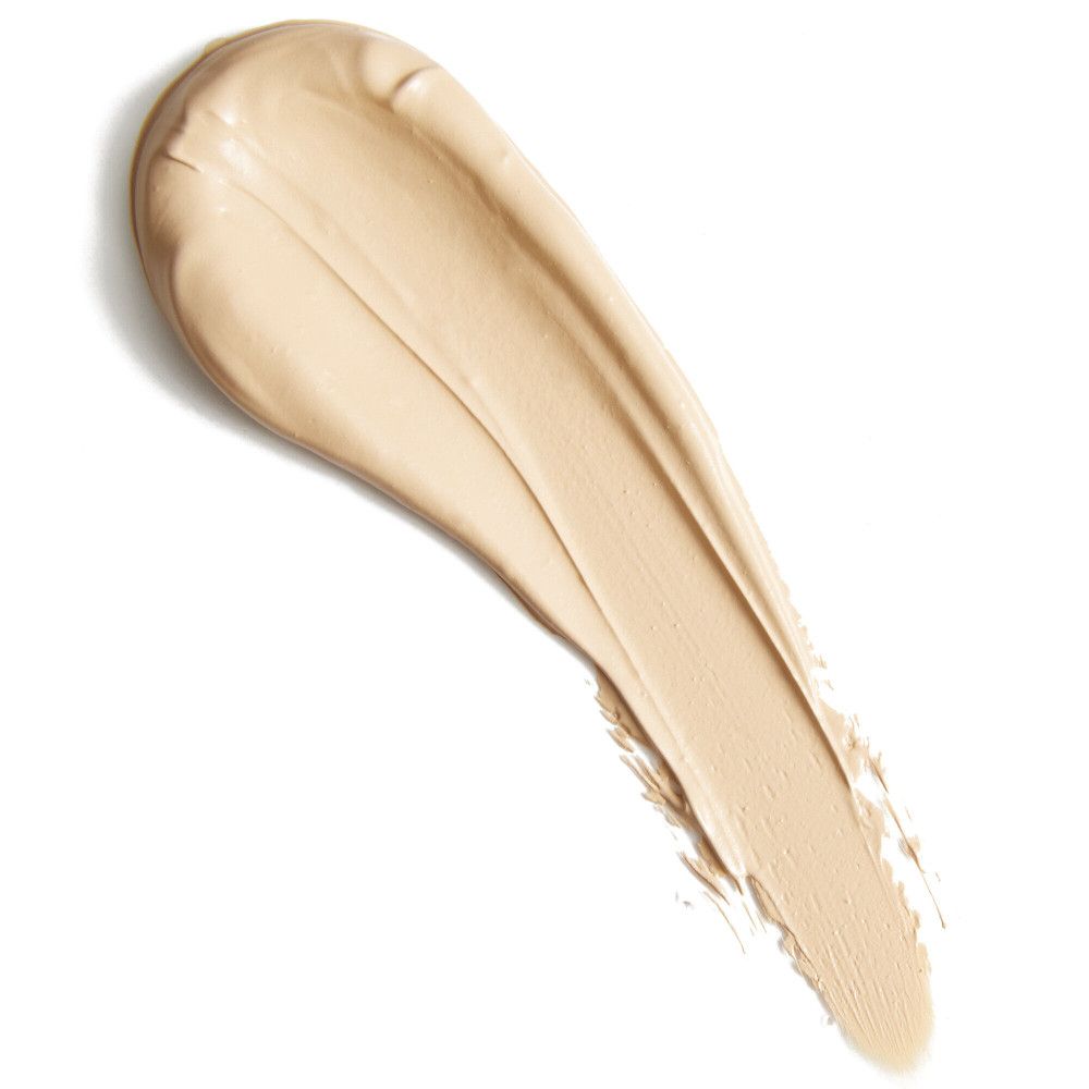 Heller, cremefarbener Concealer-Abstrich auf weißem Hintergrund. Textur und Farbton deutlich sichtbar.