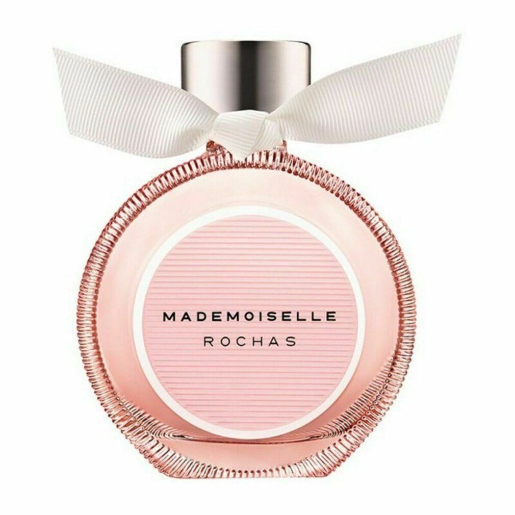 Runder Flakon mit rosa Flüssigkeit, silbernem Verschluss und weißer Schleife. Aufschrift: Mademoiselle Rochas.