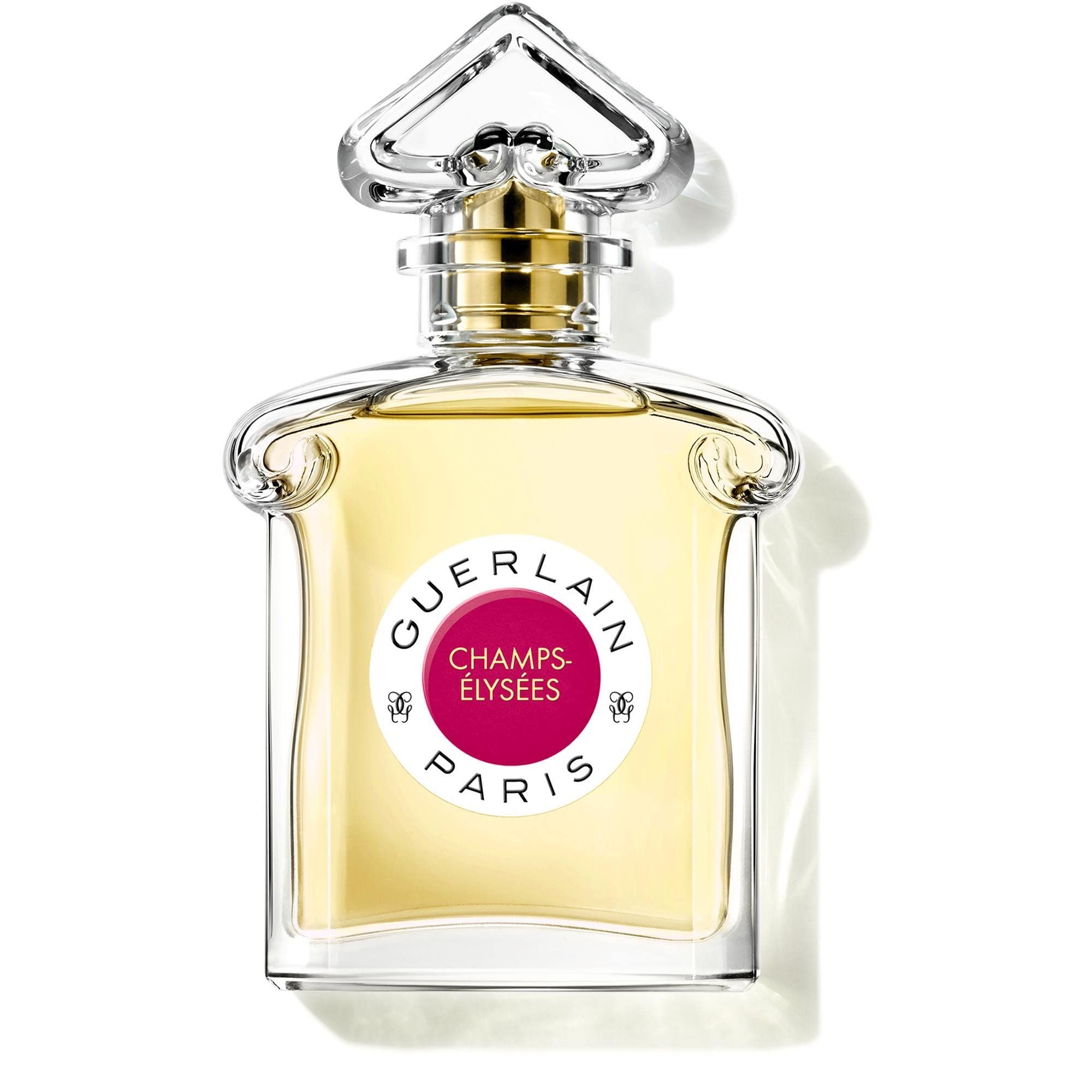 Guerlain Champs-Élysées Eau de Toilette. Glasflakon mit goldfarbenem Verschluss und rosafarbenem Etikett. Klarer, quadratischer Flakon.