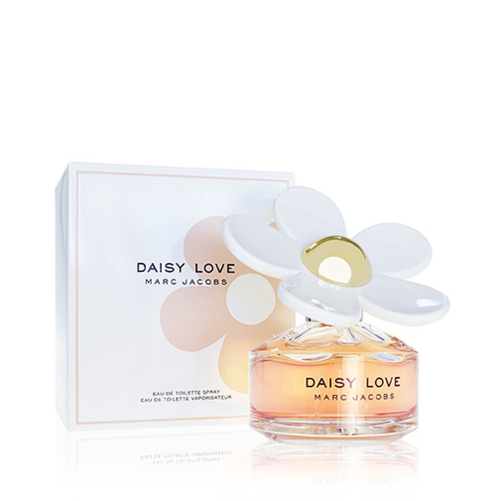 Parfümflasche und Verpackung. Flasche mit weißer Blüte und goldenem Deckel. Aufschrift: DAISY LOVE MARC JACOBS.