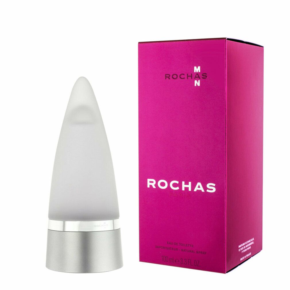 Parfümflakon neben Verpackung. Flakon konisch, silberfarben, weißes Glas. Verpackung pink, Rochas Man.