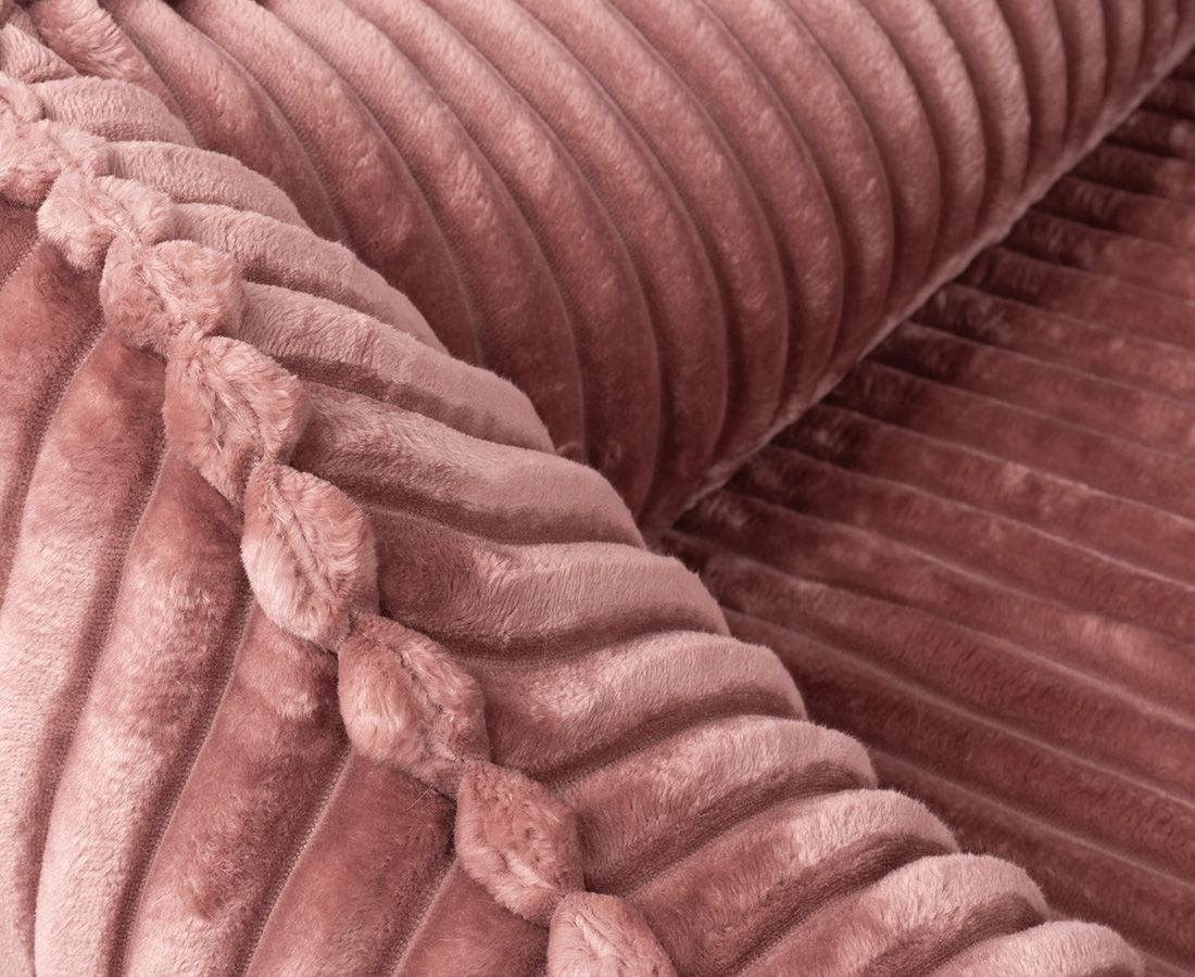 Nahaufnahme des orthopädischen Hundebetts Sedona. Rosa Cord-Optik. Detail der Oberfläche und der Ziernaht.