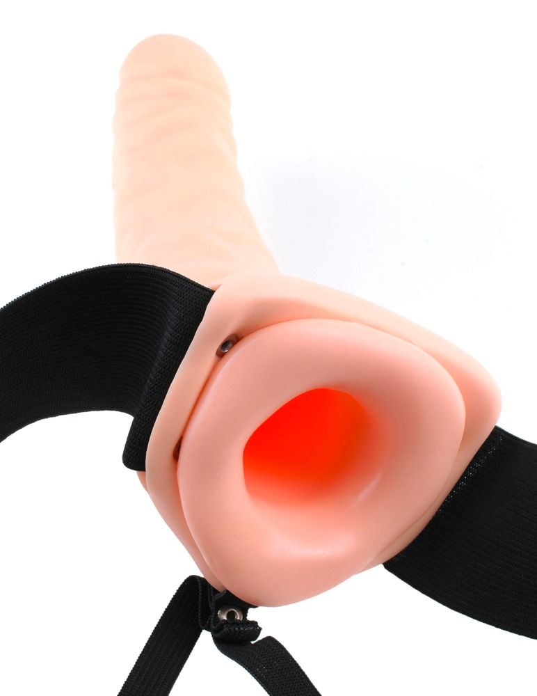 Beigefarbener Dildo mit schwarzem Harness. Sichtbare Öffnung. Detailaufnahme.