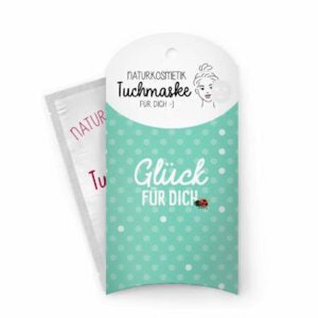 Gesichtsmaske in Verpackung. Türkis-weiß gepunktet. Schriftzug: Glück für dich. Naturkosmetik Tuchmaske.