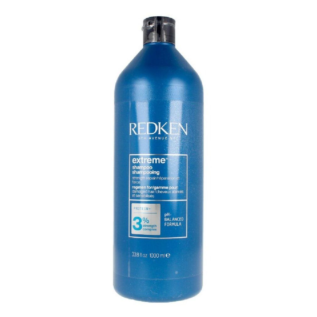Blaue Flasche Redken Extreme Shampoo. Schwarzer Deckel. Text: Extreme Shampoo, pH-ausgewogene Formel, 1000 ml.