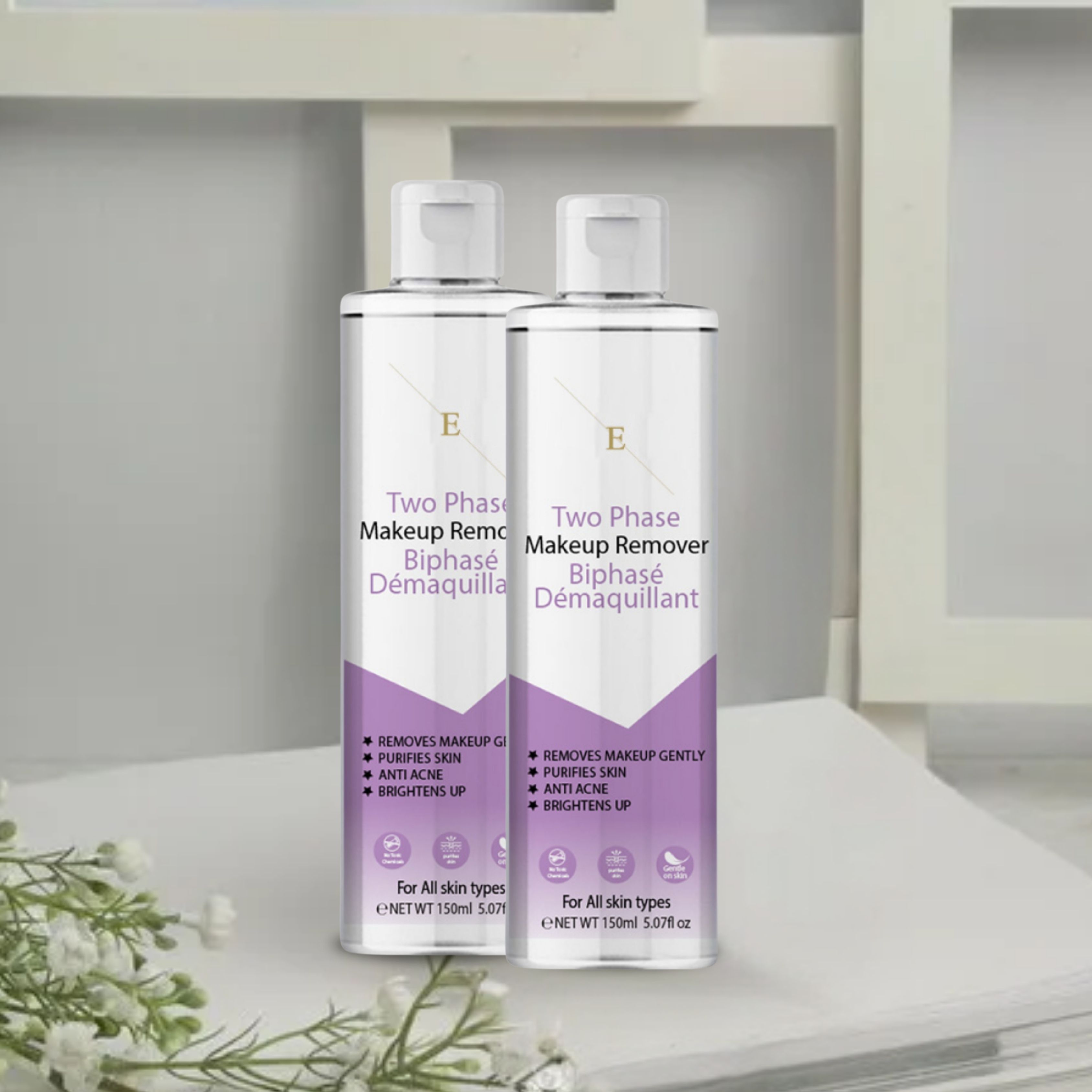 Twee flessen tweefasige make-up remover. Witte doppen, transparante flessen met paarse etiketten. Tekst: "Two Phase Makeup Remover".