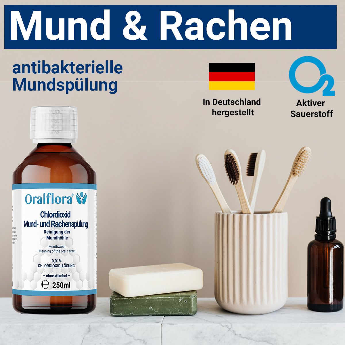 Braune Flasche mit weißem Etikett. Aufschrift: Oralflora Chlordioxid Mund- und Rachenspülung. 250ml. Mit Zahnbürsten und Seife.
