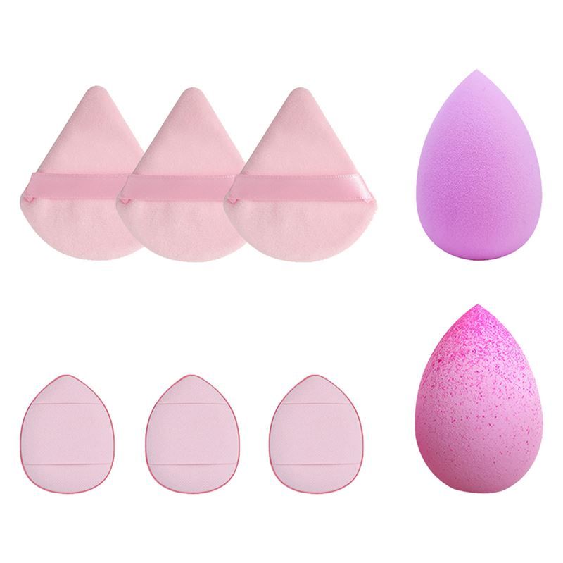 Make-up-Schwämme in verschiedenen Formen. Dreieckige Schwämme mit Bändern und tropfenförmige Schwämme. Mehrere Schwämme sind sichtbar.