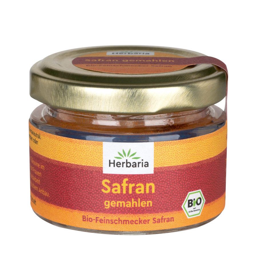 Glas mit Safran, gemahlen. Etikett mit Logo, Produktname und Bio-Siegel. Goldfarbener Deckel.
