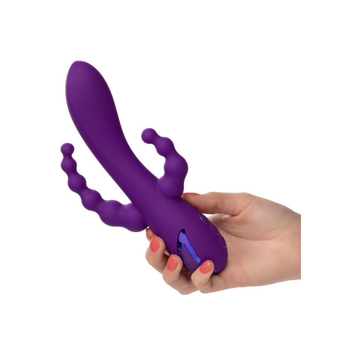 Lila Vibrator, gehalten von einer Hand. Gebogene Form mit strukturierten Elementen.