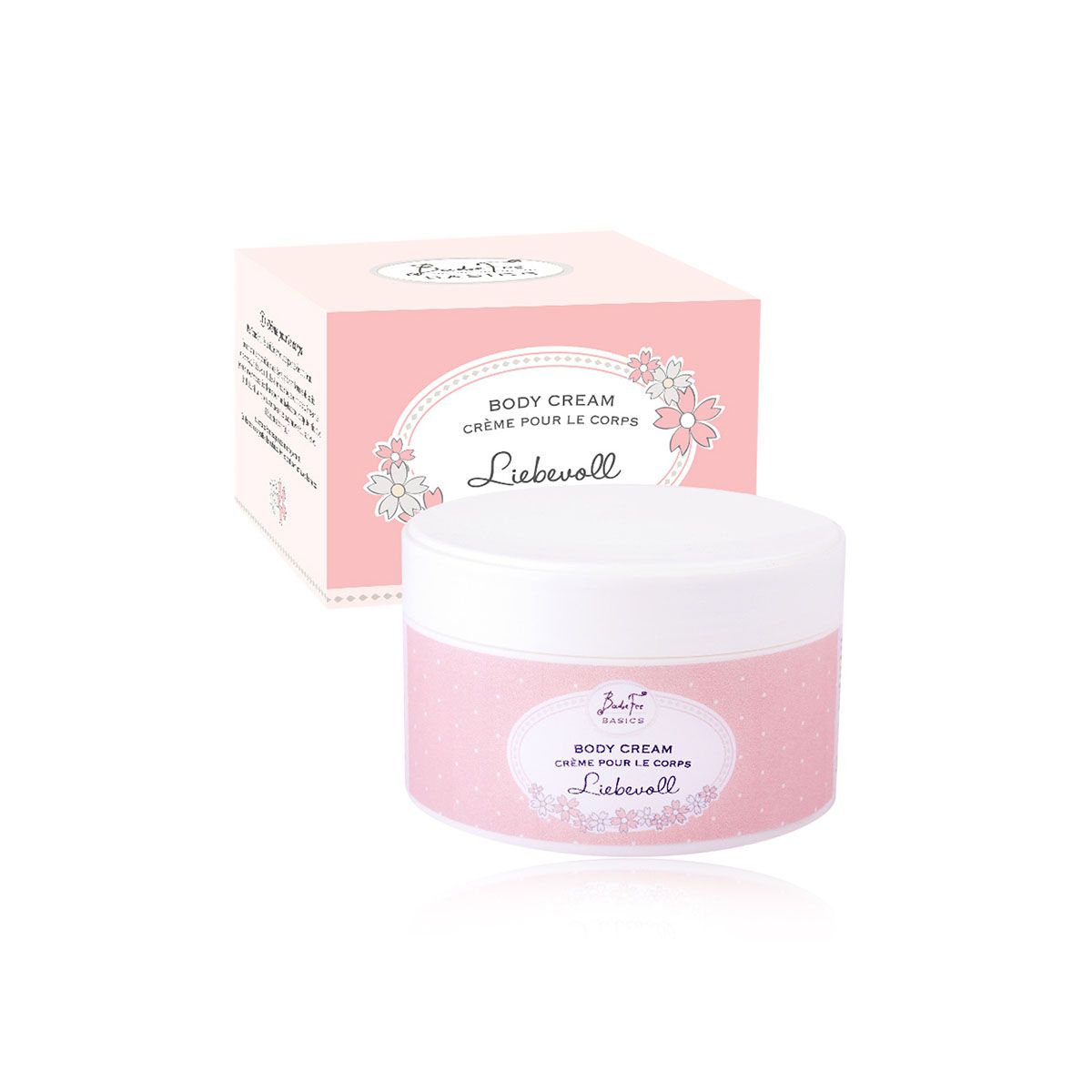 Rosa Tiegel mit weißem Deckel und rosa Verpackung. Aufschrift: Body Cream, Crème pour le corps, Liebevoll. Blumenmuster.