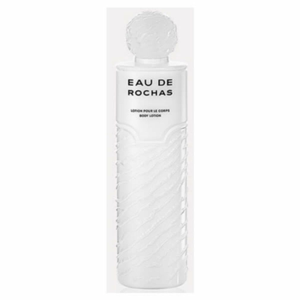 Weiße Flasche mit Kugelverschluss. Aufschrift: Eau de Rochas, Lotion pour le corps. Geriffelte Oberfläche.