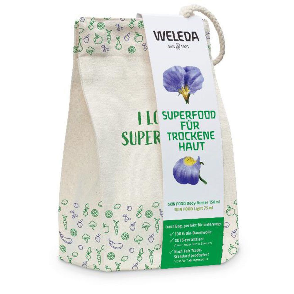 Beige Stofftasche mit Aufdrucken und Anhänger. Aufschrift: SUPERFOOD FÜR TROCKENE HAUT. Marke: WELEDA.