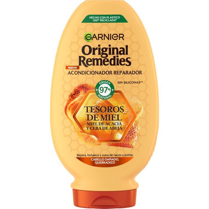 Gelbliche Flasche mit Garnier Original Remedies Conditioner. Aufschrift: Tesoros de Miel, Miel de Acacia y Cera de Abeja. 97% natürlichen Ursprungs.
