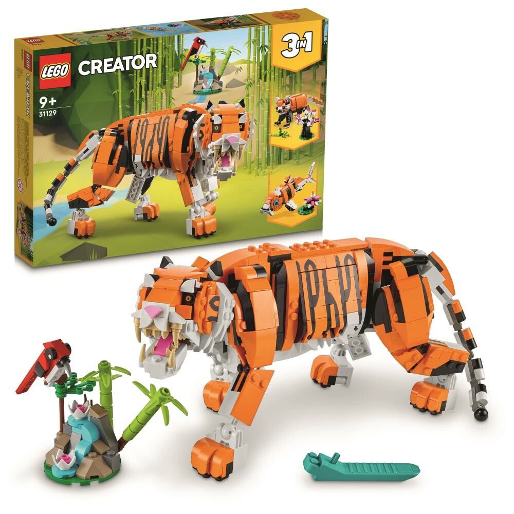 Set LEGO Creator 3 in 1 con una maestosa tigre. Il set include mattoncini per costruire una tigre, un pesce e un uccello rosso. La confezione mostra la tigre in un ambiente giungla. Adatto a bambini dai 9 anni in su.