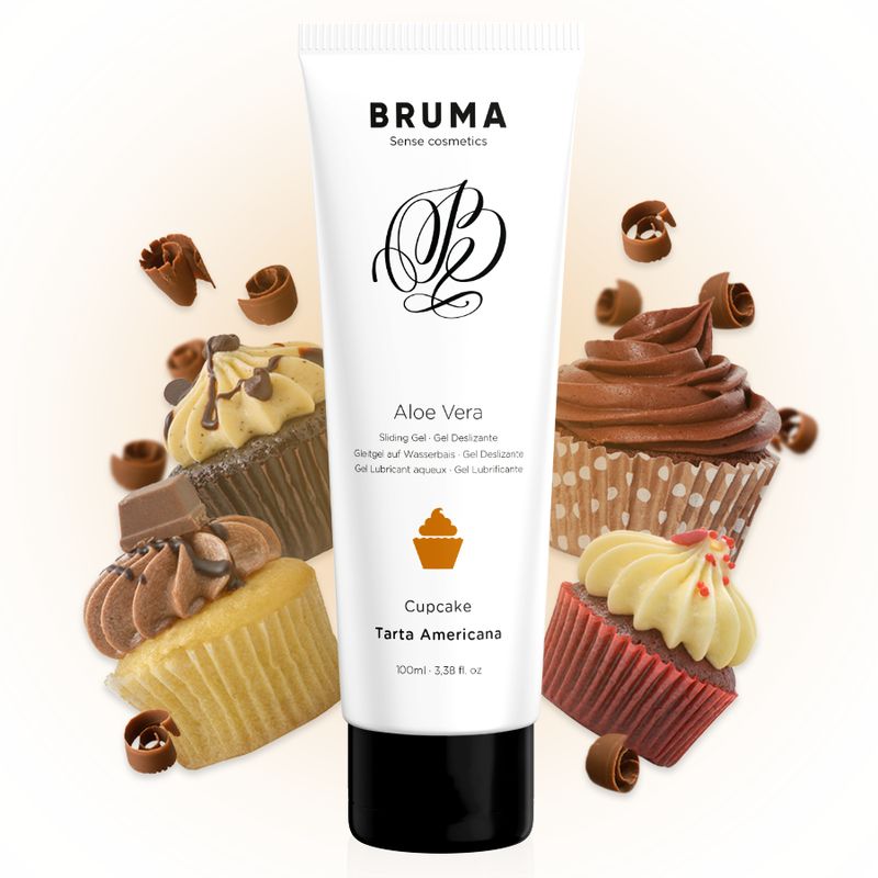 Eine Tube Aloe Vera Gleitgel Cupcake Tarta Americana umgeben von Cupcakes und Schokoladenlocken.