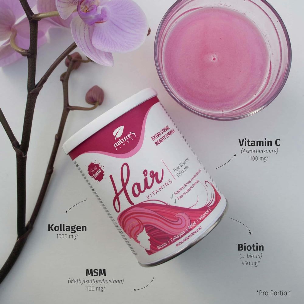 Glas mit rosa Flüssigkeit, Dose Nature's Finest Hair Vitamins. Inhaltsstoffe: Vitamin C, Kollagen, MSM, Biotin. Dekoration.