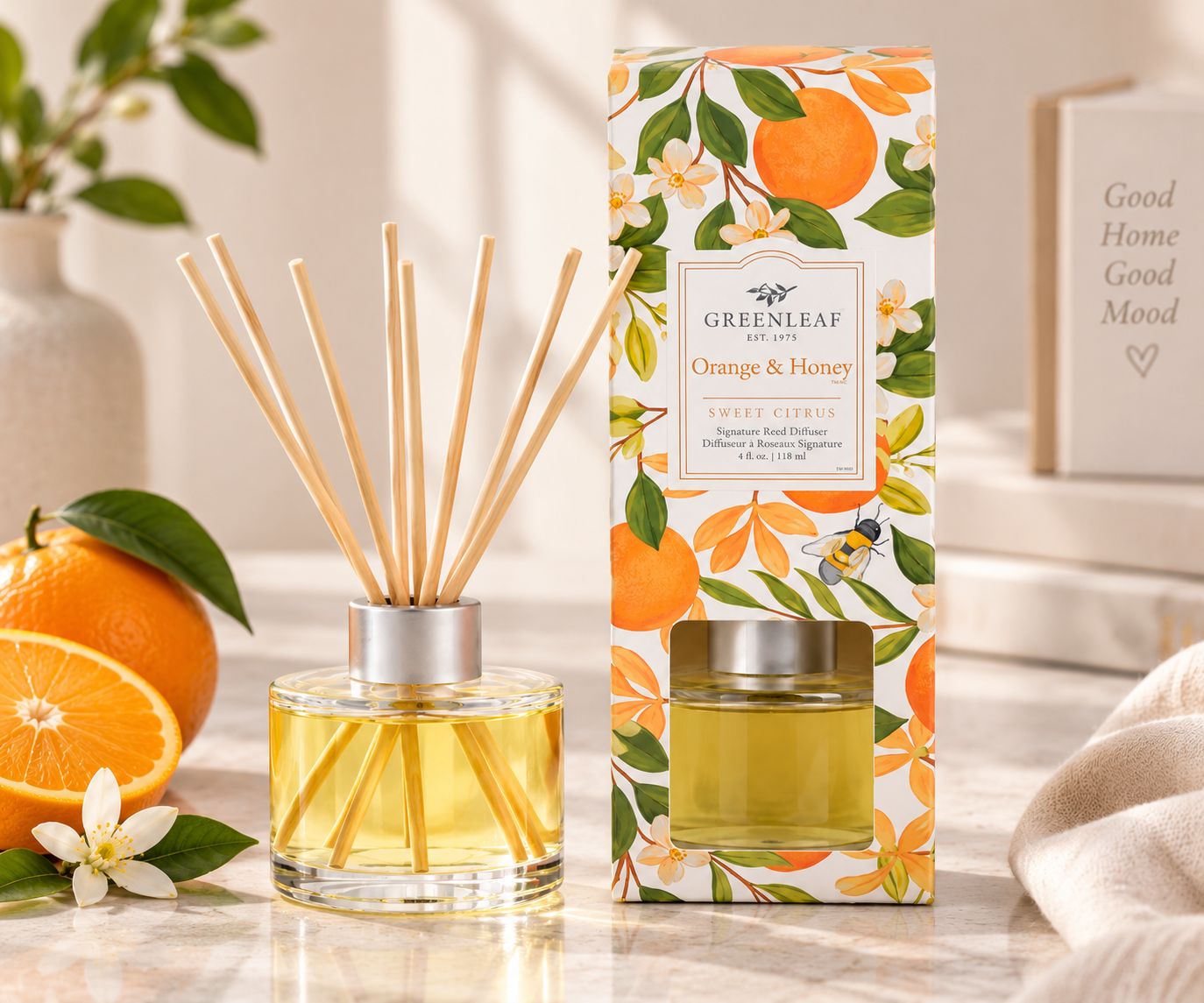 Greenleaf Orange & Honey Reed Diffuser mit Orangen, Blumen und Biene auf der Verpackung.