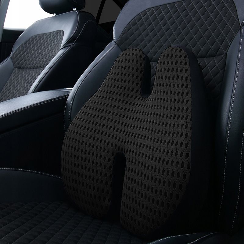 Schwarzes ergonomisches Sitzkissen mit U-förmigem Design und atmungsaktivem Netzbezug, platziert auf einem Autositz.