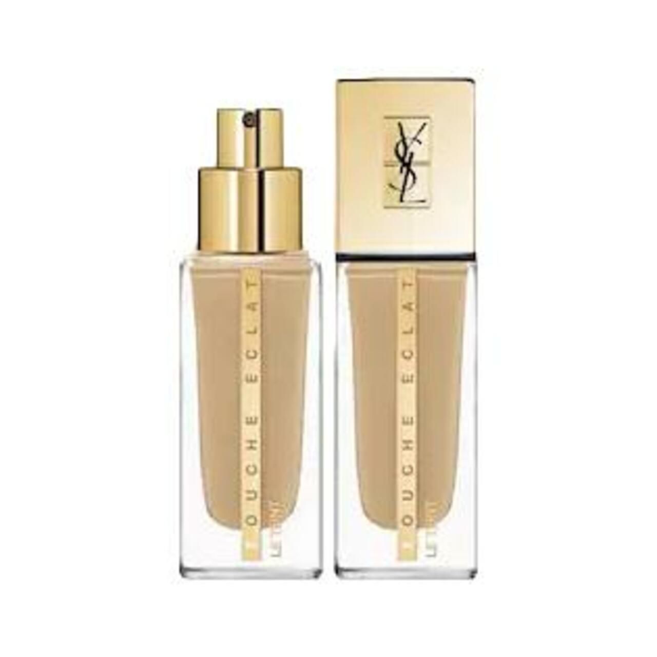 Zwei Yves Saint Laurent Touche Éclat Le Teint Foundation Flaschen. Goldfarbene Deckel und Flaschen.