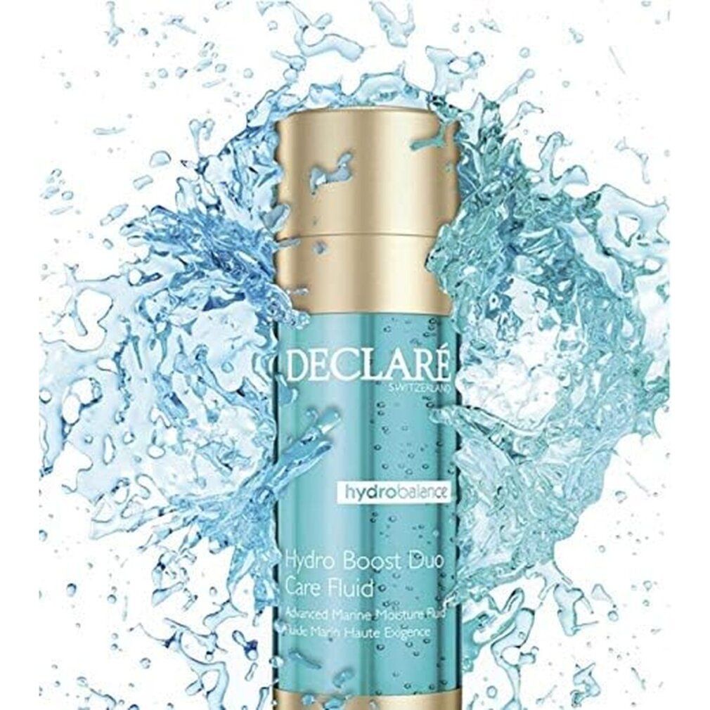 Zylinderförmige Flasche mit blauem Inhalt, goldfarbenen Deckel und Boden. Beschriftung: DECLARÉ, hydrobalance, Hydro Boost Duo Care Fluid.