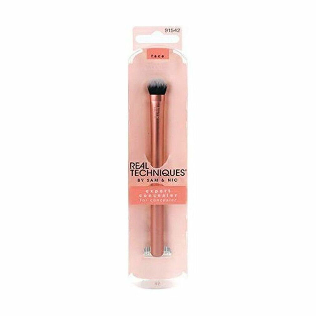 Verpackung mit einem Pinsel. Auf der Verpackung steht "REAL TECHNIQUES" und "EXPERT CONCEALER".