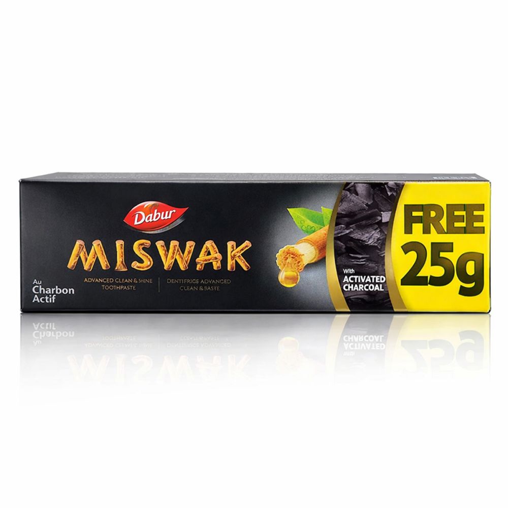 Dabur Miswak Zahnpasta mit Aktivkohle, 25g gratis. Schwarze Verpackung mit gelbem Akzent.