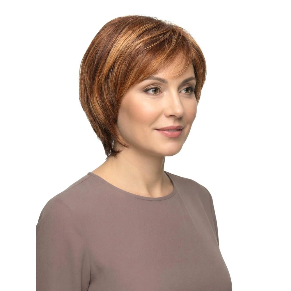 Perücke Sabine von Lofty. Kurze, rotbraune Kunsthaarperücke mit Pony. Frau mit Perücke, leicht schräg.