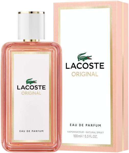 LACOSTE Original Femme EdP Nat. Spray Flakon und Verpackung. Rosa Karton mit weißem Etikett und goldenen Akzenten.