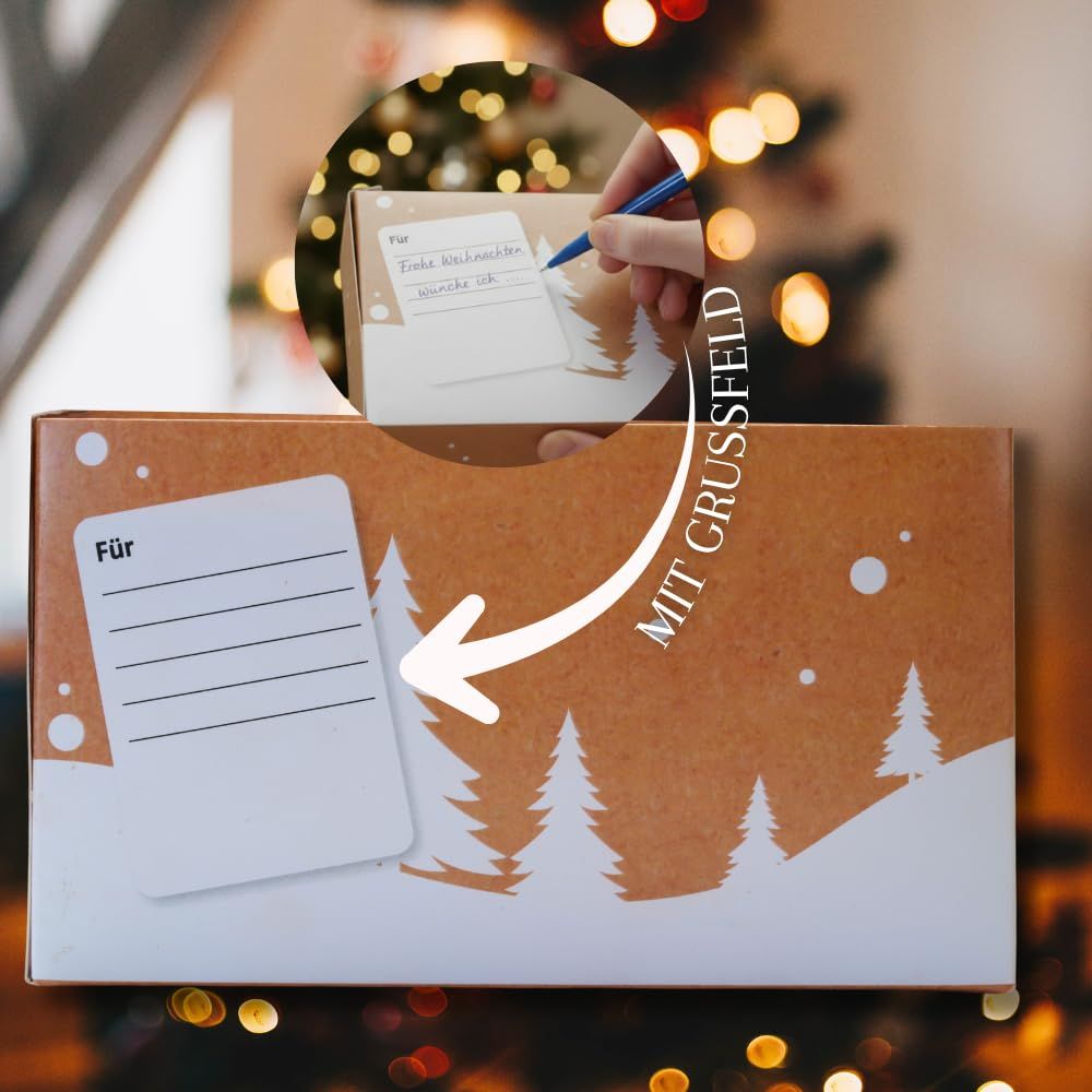 Geschenkverpackung mit Weihnachtsmotiv, gefüllt mit zwei Gläsern Honig.
