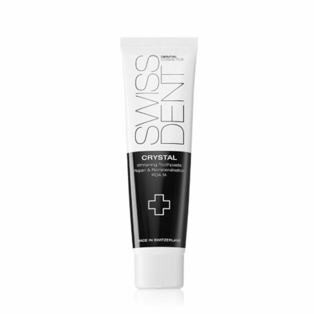 Zahncreme-Tube, weiß und schwarz. Aufschrift: SWISSDENT, CRYSTAL, Repair & Remineralisation, RDA 14. Kreuz-Symbol. Hergestellt in der Schweiz.