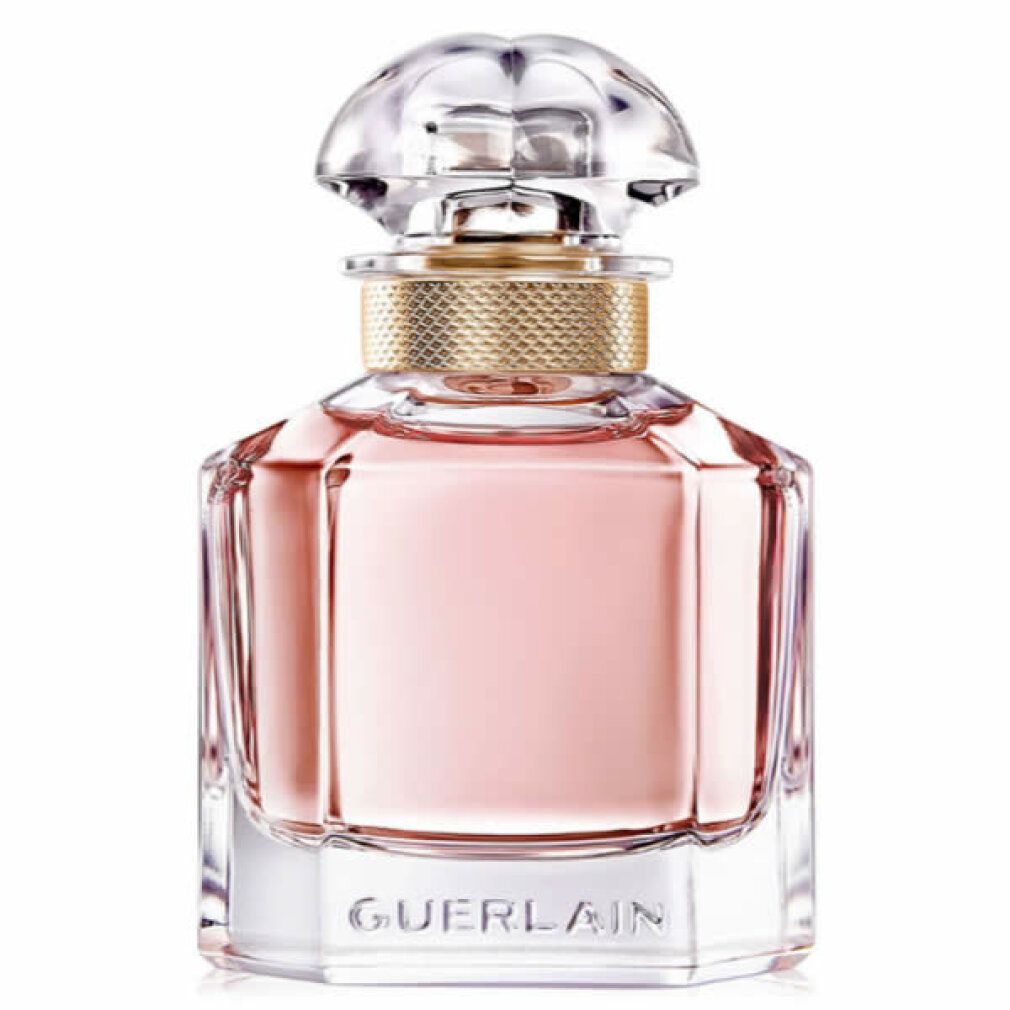 Parfümflakon mit rosa Flüssigkeit, goldfarbenem Hals und transparentem Deckel. Geometrische Form mit Schriftzug Guerlain.
