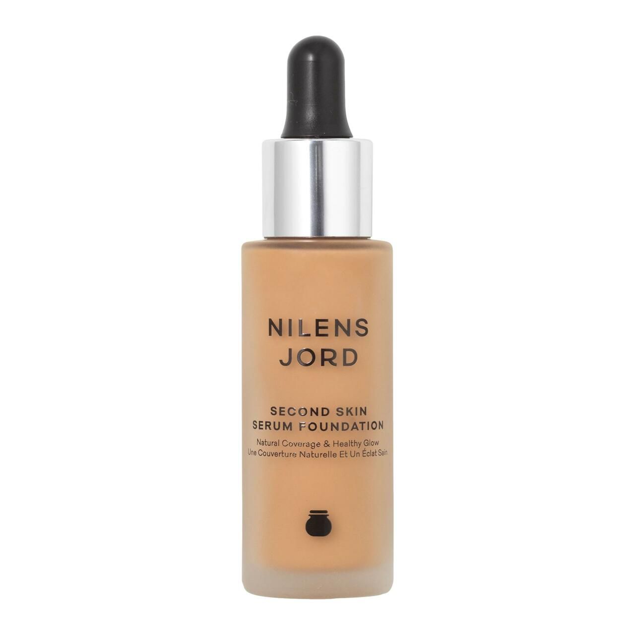 Flakon mit Serum Foundation. Aufschrift: Nilens Jord, Second Skin Serum Foundation. Mit Pipette und silbernem Verschluss.