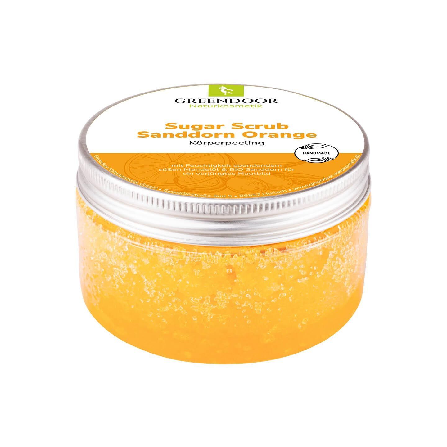 GREENDOOR Sanddorn Orange Zuckerpeeling in einem transparenten Behälter mit silbernem Deckel.