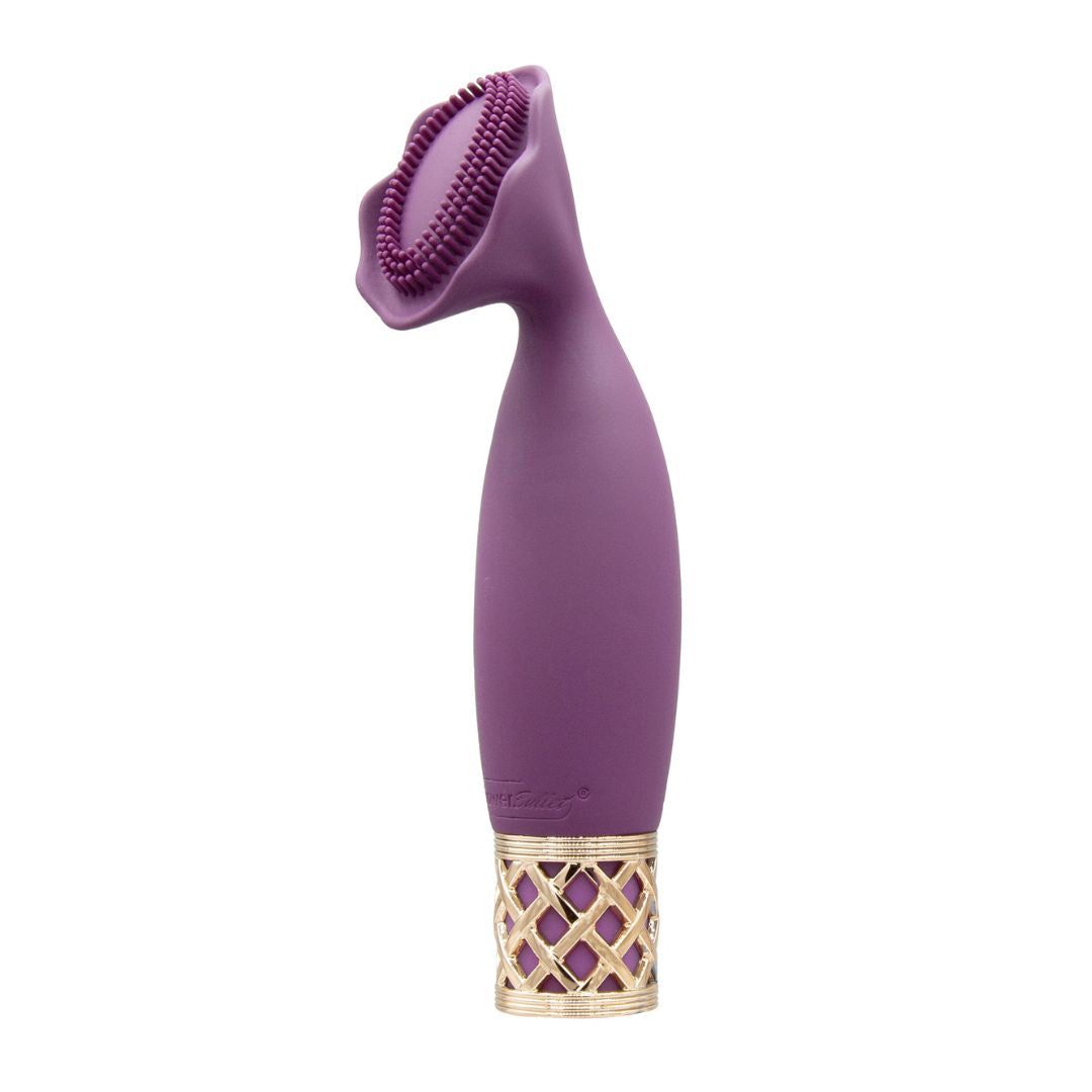 Lila Auflegevibrator mit goldfarbenem Zierring. Oben blütenförmiger Aufsatz mit Noppen.