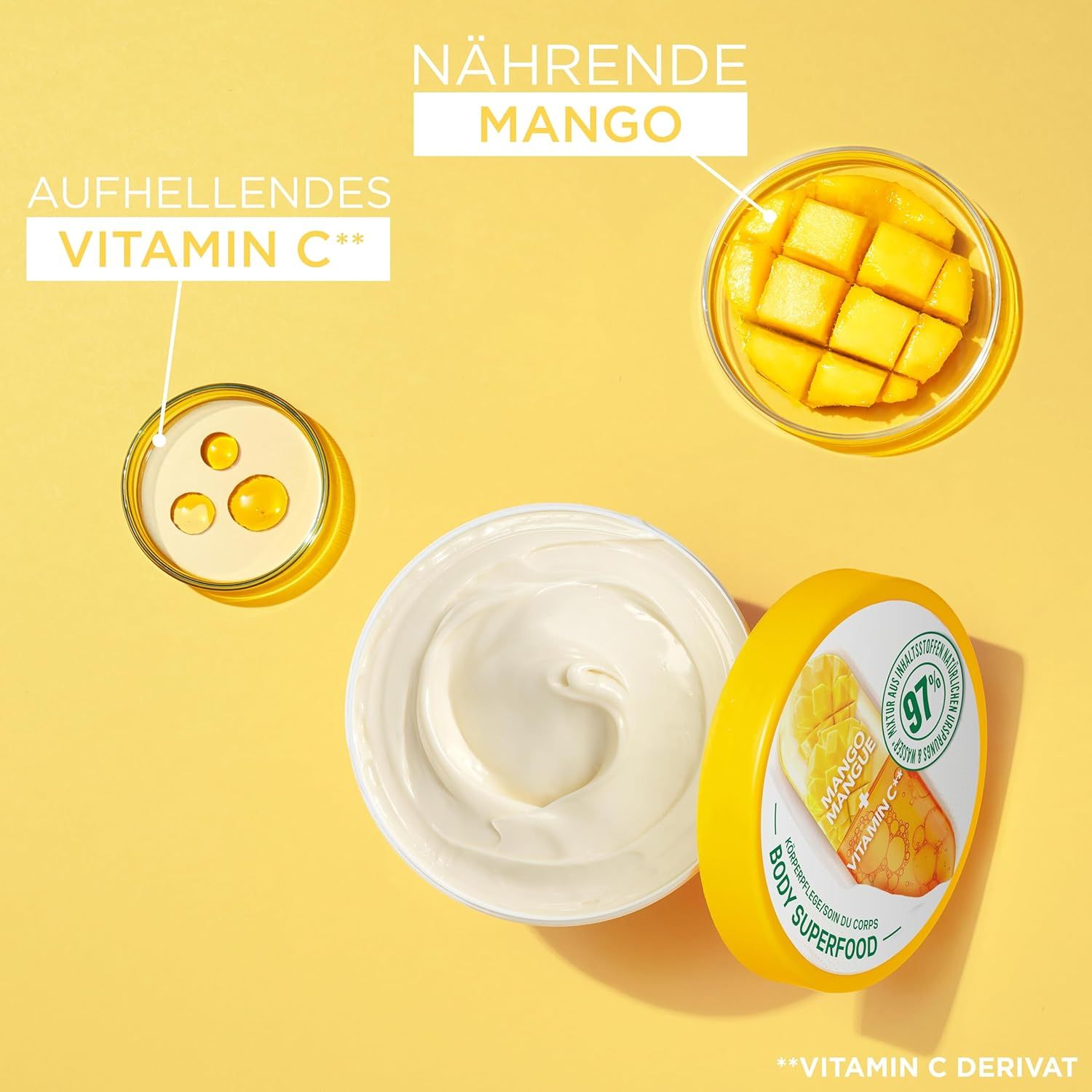 Geöffneter Tiegel mit Creme, gelber Deckel. Aufschrift: Garnier Vitamin C Body Superfood. Mango- und Vitamin C-Abbildungen. Inhaltsstoffe.