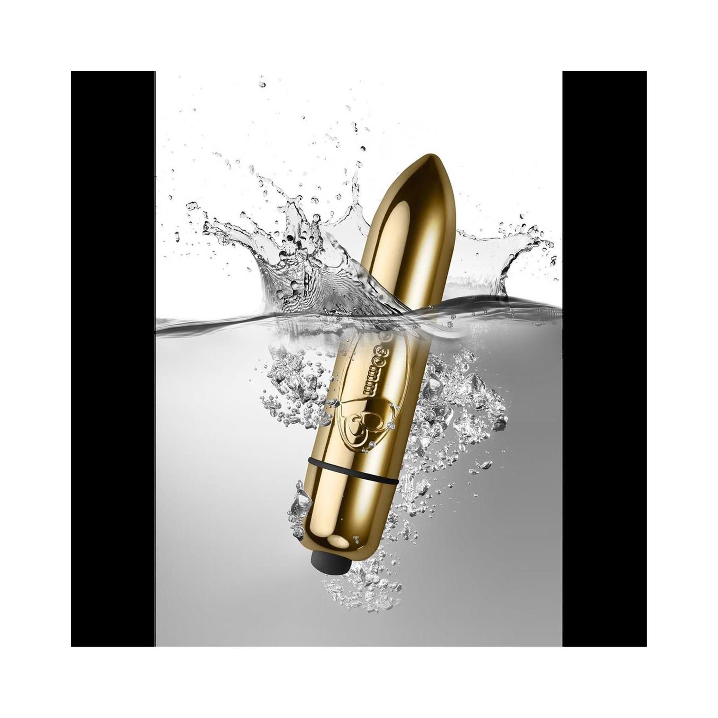 Goldfarbenes, zylindrisches Produkt im Wasser. Schwarzes Ende.