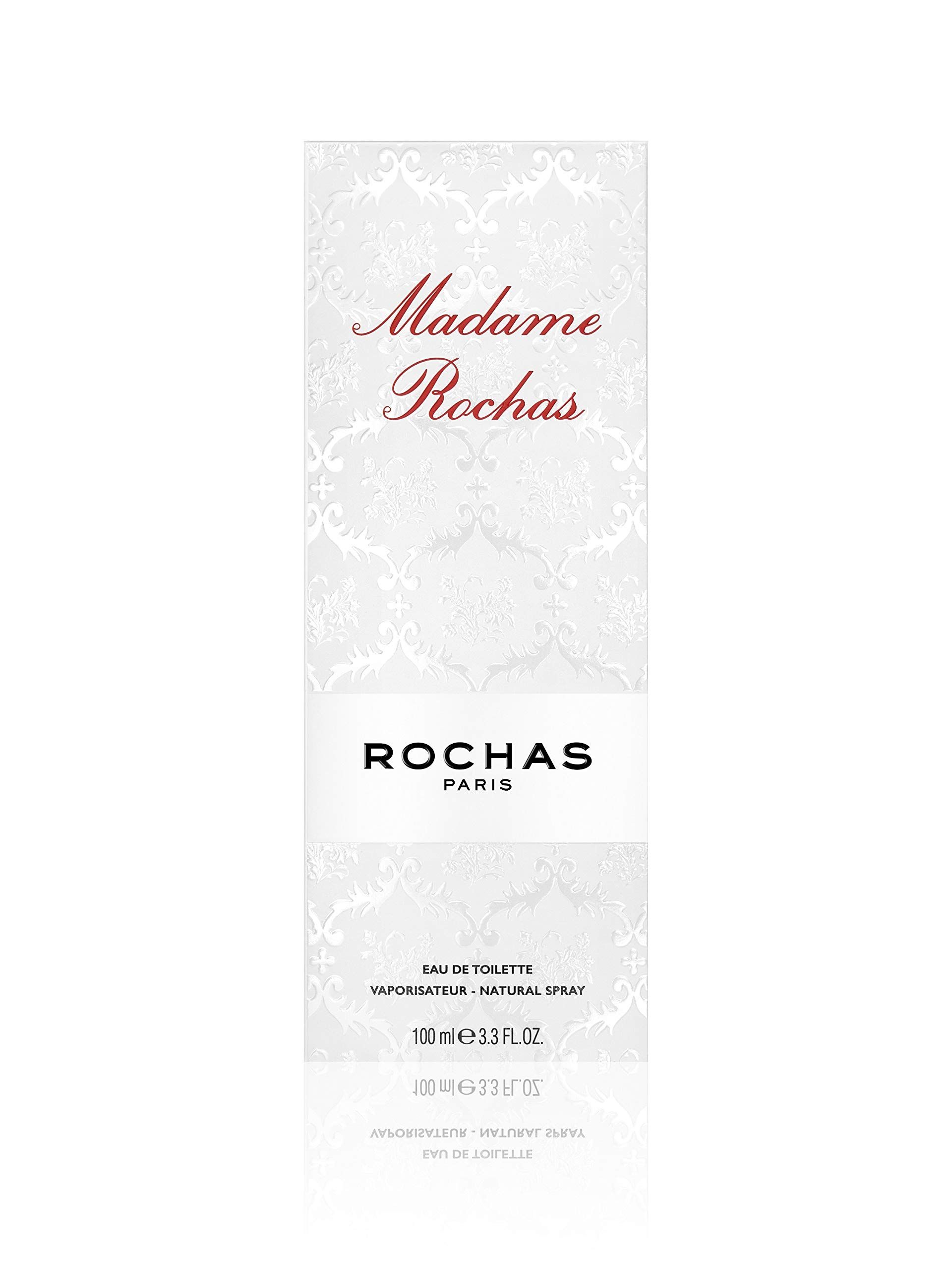 Weiße Verpackung mit Muster und roter Schrift: Madame Rochas. Darunter: Rochas Paris. Unten: Eau de Toilette, Natural Spray.