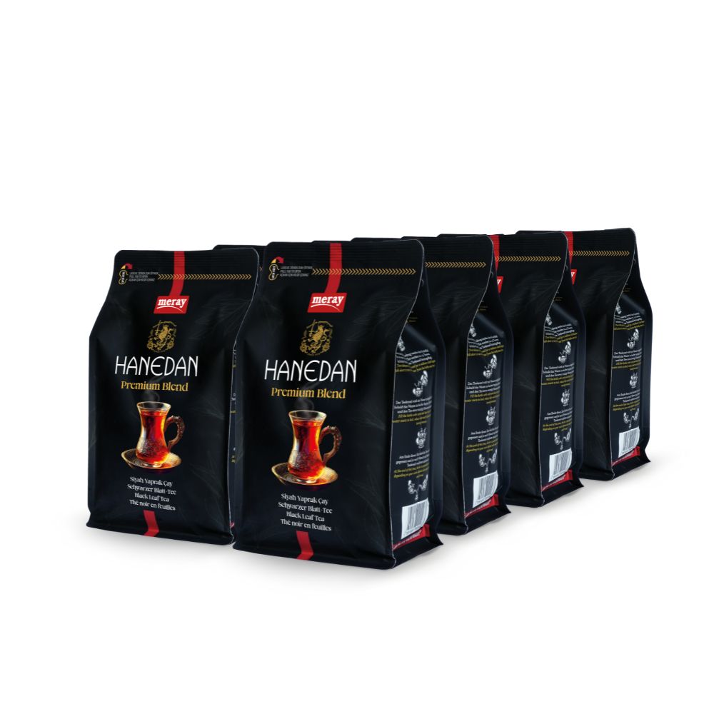 Sechs schwarze Beutel mit dem Aufdruck "HANEDAN Premium Blend". Aufdruck zeigt eine Teetasse. Roter Streifen und Logo oben.