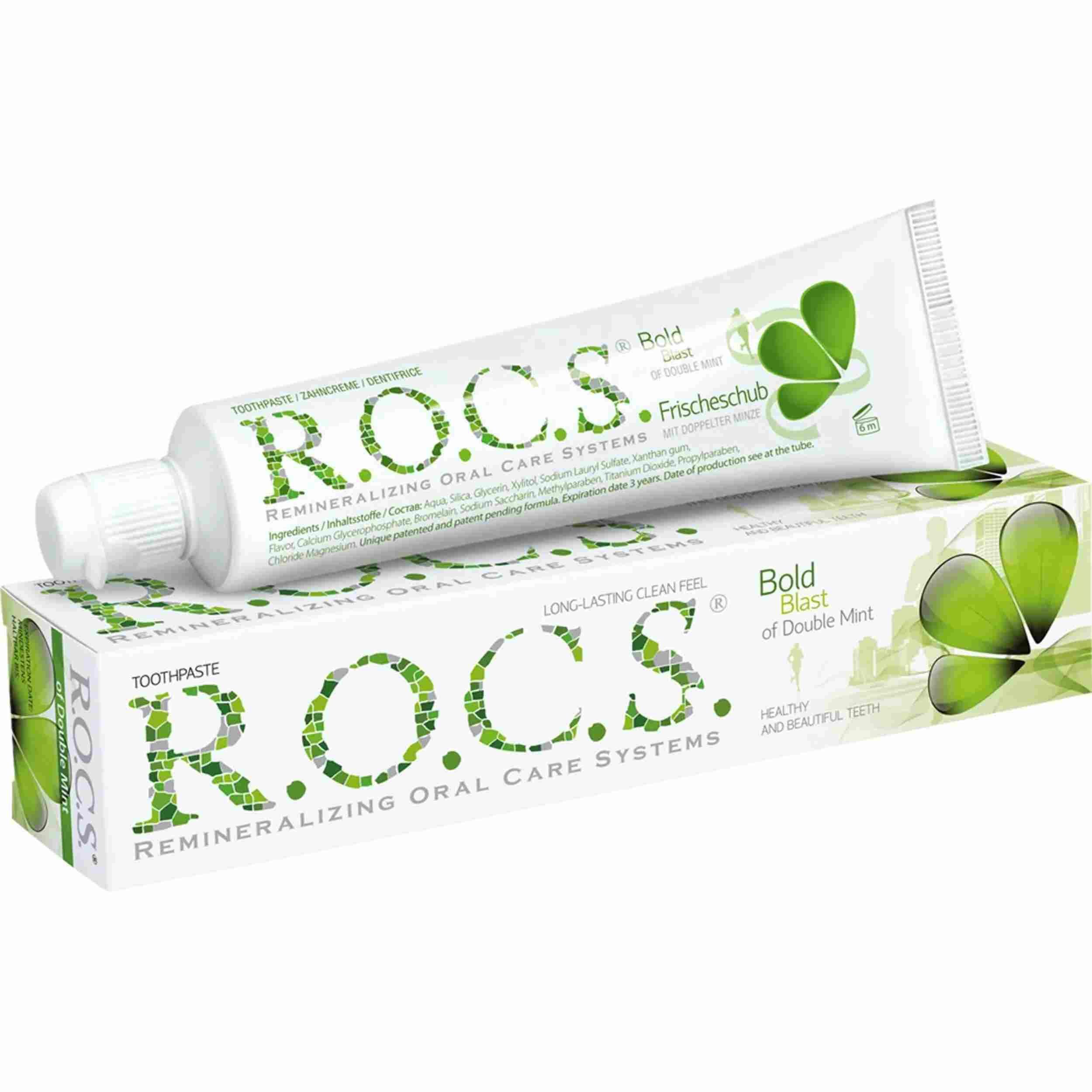 Zahncreme und Schachtel. Aufschrift: R.O.C.S. Doppelminze. Grün-weiße Verpackung. Text: Bold Blast of Double Mint.
